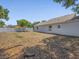Large backyard featuring privacy fence, mature trees and rear view of the home at 150 Bentley Oaks Blvd, Davenport, FL 33896