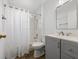Bright bathroom featuring a shower-tub combo, gray vanity with white countertop, and wood-look flooring at 150 Bentley Oaks Blvd, Davenport, FL 33896