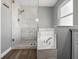 Bathroom with marble shower, tub and wooden floors at 150 Bentley Oaks Blvd, Davenport, FL 33896