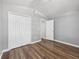 Neutral bedroom featuring wood-look floors, closet, and door at 150 Bentley Oaks Blvd, Davenport, FL 33896
