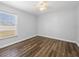 Bedroom with hardwood floors, a ceiling fan, and a window providing natural light at 150 Bentley Oaks Blvd, Davenport, FL 33896