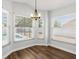 A sunny breakfast nook with bright windows and a chandelier, overlooking the pool area at 150 Bentley Oaks Blvd, Davenport, FL 33896