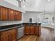 A kitchen showcasing wood cabinets, granite countertops, and stainless steel appliances, with a pool view through the window at 150 Bentley Oaks Blvd, Davenport, FL 33896