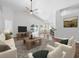 Open living space with vaulted ceilings, wood flooring, and natural light at 150 Bentley Oaks Blvd, Davenport, FL 33896