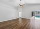 Open living space with wood floors, a ceiling fan, and access to the outdoor pool area at 150 Bentley Oaks Blvd, Davenport, FL 33896