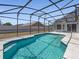 Backyard pool area with screened-in pool and concrete deck at 150 Bentley Oaks Blvd, Davenport, FL 33896