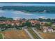 Breathtaking aerial view of a charming community near a tranquil lake at 16808 Bolsena Dr, Bella Collina, FL 34756