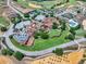 Aerial view of a community with a pool, tennis courts, and well-maintained landscaping at 16808 Bolsena Dr, Bella Collina, FL 34756