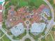 Bird's-eye view of community center with its unique architecture, parking and lush landscaping at 16808 Bolsena Dr, Bella Collina, FL 34756