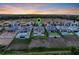 Aerial view of a suburban neighborhood featuring modern homes, some with pools, nestled in a scenic landscape at 16808 Bolsena Dr, Bella Collina, FL 34756