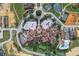 Overhead view reveals a community center with pool, tennis courts, and parking at 16808 Bolsena Dr, Bella Collina, FL 34756