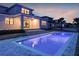 Evening shot of a backyard with a stunning pool, patio, and landscape that is ideal for entertaining at 16808 Bolsena Dr, Bella Collina, FL 34756