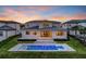 Backyard featuring a pool, manicured lawn, and modern architecture, providing an ideal outdoor living space at 16808 Bolsena Dr, Bella Collina, FL 34756