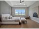 Spacious bedroom with modern decor featuring tray ceilings and a large window offering scenic views at 16808 Bolsena Dr, Bella Collina, FL 34756