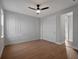 Bright bedroom with wood floors, decorative wall molding, ceiling fan, and closet at 16808 Bolsena Dr, Bella Collina, FL 34756