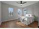 Cozy bedroom with wood floors and bright natural light from three windows at 16808 Bolsena Dr, Bella Collina, FL 34756