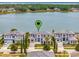 Luxury waterfront home with modern design, lush landscaping, and serene lake views at 16808 Bolsena Dr, Bella Collina, FL 34756