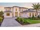 Elegant two-story home features a light stone facade, paved driveway and a spacious three-car garage at 16808 Bolsena Dr, Bella Collina, FL 34756
