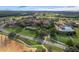 Stunning stone mansion, with manicured lawn, mature trees, and a luxurious pool area at 16808 Bolsena Dr, Bella Collina, FL 34756