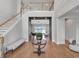 Elegant foyer with a grand staircase, hardwood floors, and a view into the living area with water views at 16808 Bolsena Dr, Bella Collina, FL 34756