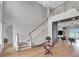 Impressive foyer with soaring ceilings, wooden staircase, and stylish decor, creating a welcoming entrance at 16808 Bolsena Dr, Bella Collina, FL 34756