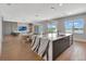 Spacious living area showcases a sleek kitchen island and dining space with water views at 16808 Bolsena Dr, Bella Collina, FL 34756