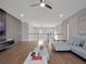 Open living space with wood floors, gray accent wall, modern lighting, and comfortable sofa at 16808 Bolsena Dr, Bella Collina, FL 34756