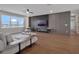 Modern living room with lake views, contemporary furnishings, and stylish entertainment center at 16808 Bolsena Dr, Bella Collina, FL 34756