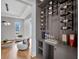 Stylish wine bar area features a modern wine rack, shelving, and a cozy seating area at 16808 Bolsena Dr, Bella Collina, FL 34756