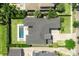 Bird's eye view of a property featuring a modern pool, manicured lawn, and large home at 1700 Palm Ave, Winter Park, FL 32789