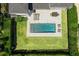 Aerial view of a backyard with a modern pool, patio area, and well-maintained green lawn at 1700 Palm Ave, Winter Park, FL 32789