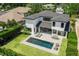 Aerial view of a modern home with a backyard oasis including a swimming pool, patio, and lush green lawn at 1700 Palm Ave, Winter Park, FL 32789