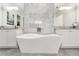 Elegant bathroom showcasing a contemporary tub, marble accents, and double sinks at 1700 Palm Ave, Winter Park, FL 32789