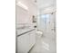 Clean bathroom features glass enclosed tub/shower, white subway tile, and a white vanity at 1700 Palm Ave, Winter Park, FL 32789