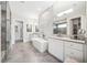 Modern bathroom featuring a standalone tub, dual vanities, and elegant tile work at 1700 Palm Ave, Winter Park, FL 32789