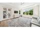 Bright bedroom with large windows, a sitting area, and hardwood floors, offering ample space at 1700 Palm Ave, Winter Park, FL 32789