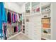 Organized walk-in closet with custom shelving, drawers, and ample storage space for clothes at 1700 Palm Ave, Winter Park, FL 32789
