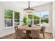 Bright dining room featuring a round table, chandelier, and large windows offering backyard views at 1700 Palm Ave, Winter Park, FL 32789