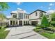 Contemporary home boasts a modern facade, two-car garage, manicured lawn, and an elegant design at 1700 Palm Ave, Winter Park, FL 32789