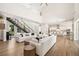 Open-concept living area featuring hardwood floors, soaring ceilings, a modern staircase, and an open kitchen at 1700 Palm Ave, Winter Park, FL 32789