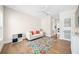 Bright living room features a white sofa with colorful pillows and an eye-catching floral rug on hardwood floors at 1700 Palm Ave, Winter Park, FL 32789