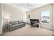 Home office with grey sofa and desk area featuring two large windows at 1700 Palm Ave, Winter Park, FL 32789