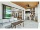 Relax on the patio near the outdoor kitchen with built in grill and appliances, and a view inside at 1700 Palm Ave, Winter Park, FL 32789