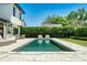 Relaxing backyard with a modern pool, elegant patio furniture, and lush green landscaping at 1700 Palm Ave, Winter Park, FL 32789