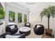 Cozy sitting room with stylish armchairs, a marble table, and natural light from large windows at 1700 Palm Ave, Winter Park, FL 32789