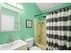 Bathroom featuring a vanity, commode, and shower/tub combo with a striped shower curtain at 1848 Jimson Ave, Ocoee, FL 34761