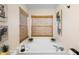 A bathtub nook with lots of natural light and tropical artwork at 1848 Jimson Ave, Ocoee, FL 34761