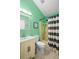 Bathroom featuring a vanity, commode, and shower/tub combo with a striped shower curtain at 1848 Jimson Ave, Ocoee, FL 34761