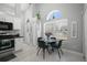 Bright dining area with arched window, table, and view of the kitchen at 1848 Jimson Ave, Ocoee, FL 34761