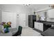 Bright kitchen featuring white cabinets, black appliances, wood-look tile floors, and an eat-in area at 1848 Jimson Ave, Ocoee, FL 34761